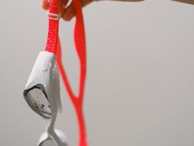 Close-up of a hand gripping a simple piece of equipment.